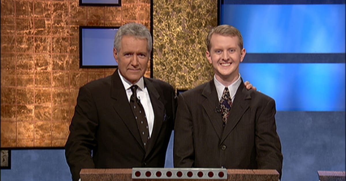 Jeopardy host Alex Trebek, (L) poses contestant Ken Jennings after his earnings from his record breaking streak on the gameshow surpassed 1 million dollars July 14, 2004 in Culver City, California. (Photo by Jeopardy Productions via Getty Images)