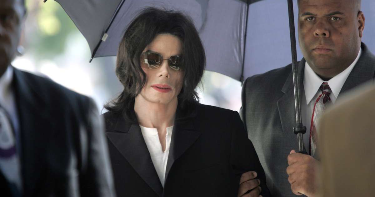 Michael Jackson enters the courthouse after arriving late at Santa Barbara County Superior Court on March 10, 2005, in Santa Maria, California. (Cover image source: Pool photo by Kimberly White | Getty Images)