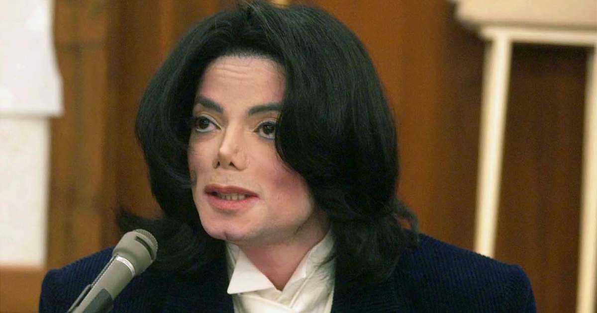 Pop star Michael Jackson speaks with photographers during a break in his testimony on December 3, 2002, in Santa Maria, California. (Image Source: Getty Images | Photo by Jim Ruymen)