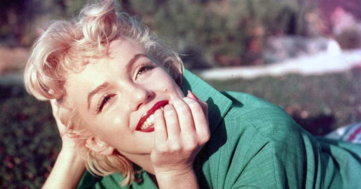 Marilyn Monroe poses for a portrait lying on the grass in 1954 in Palm Springs, California (Cover Image Source: Getty Images| Photo by Baron)