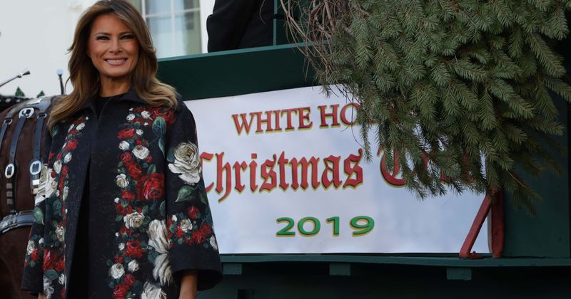 Melania Trump looks stylish as she steps out in floral Dolce & Gabbana coat and Christian Louboutin boots to receive White House Christmas tree 