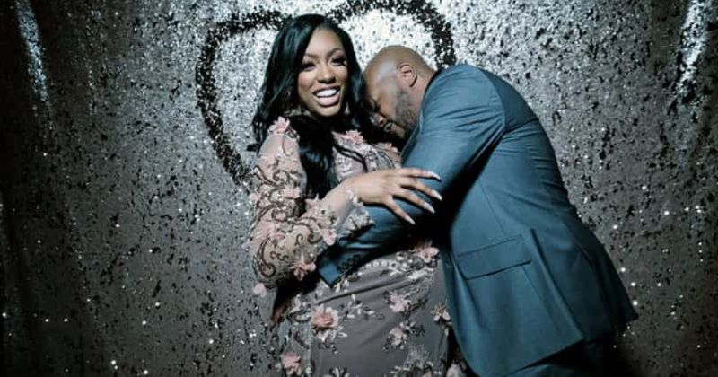 Dennis McKinley hugs 'Real Housewives of Atlanta' star Porsha Williams as she poses happily at her baby shower (Bravo TV )