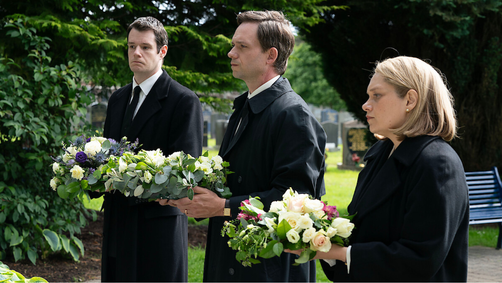 Connor Swindells as Ed McCusker, Patrick J. Adams as Dick Marquise and Merritt Wever as Kathryn Turman attend a memorial in ‘The Bombing of Pan Am 103’ (Image Source: Netflix | Tudum)