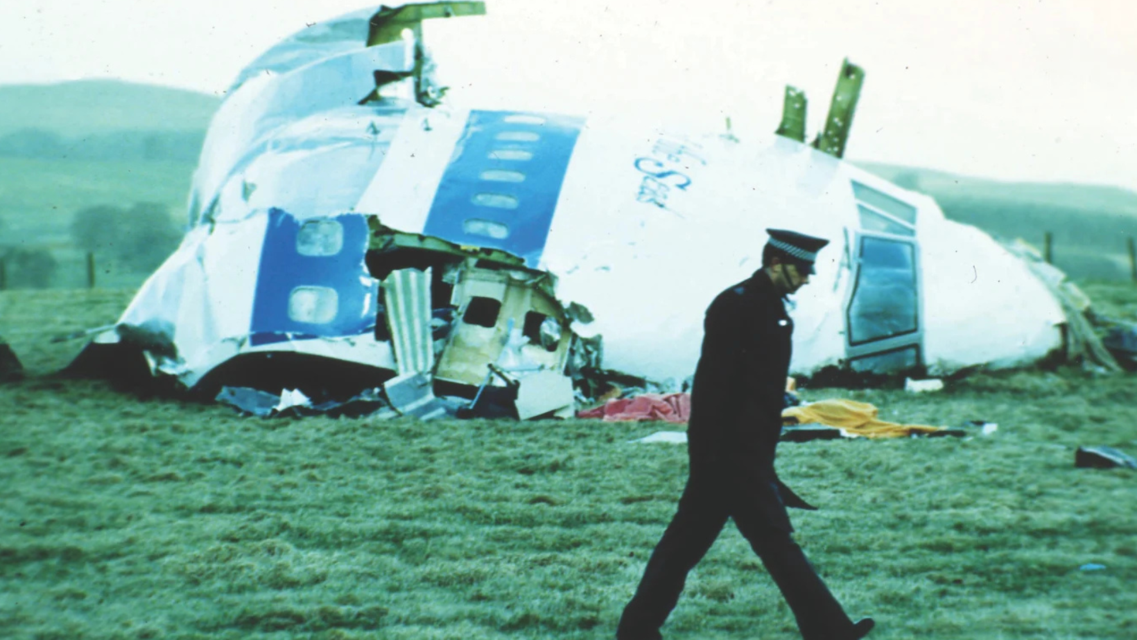 A Scottish Police officer surveys wreckage of Pan Am Flight 103 in Lockerbie, Scotland.