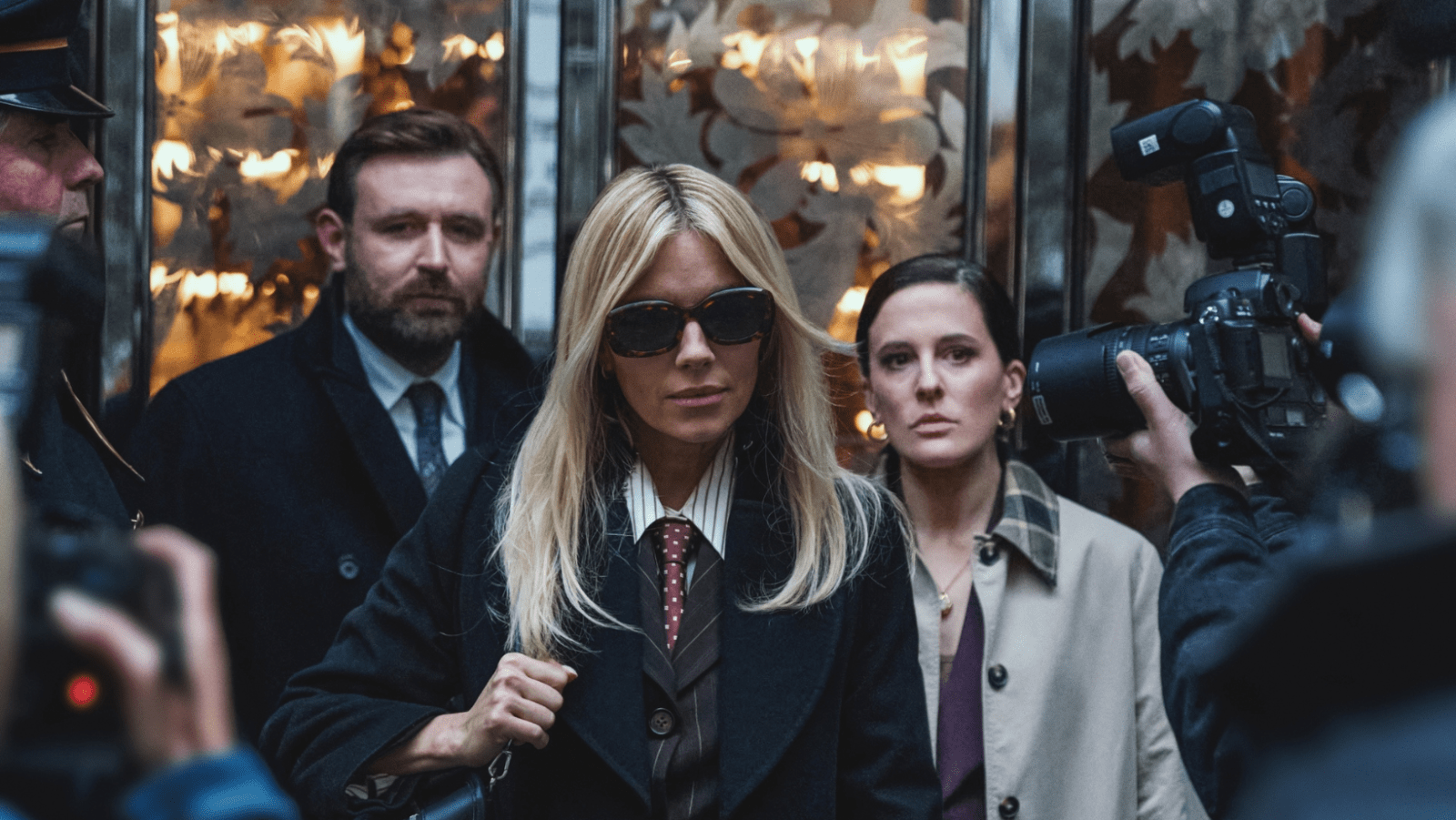 Sienna Miller as Carla Duval, with James McArdle as Nicholas Taylor and Phoebe Fox as Serena Byrne, in ‘War’ (Image Source: HBO)