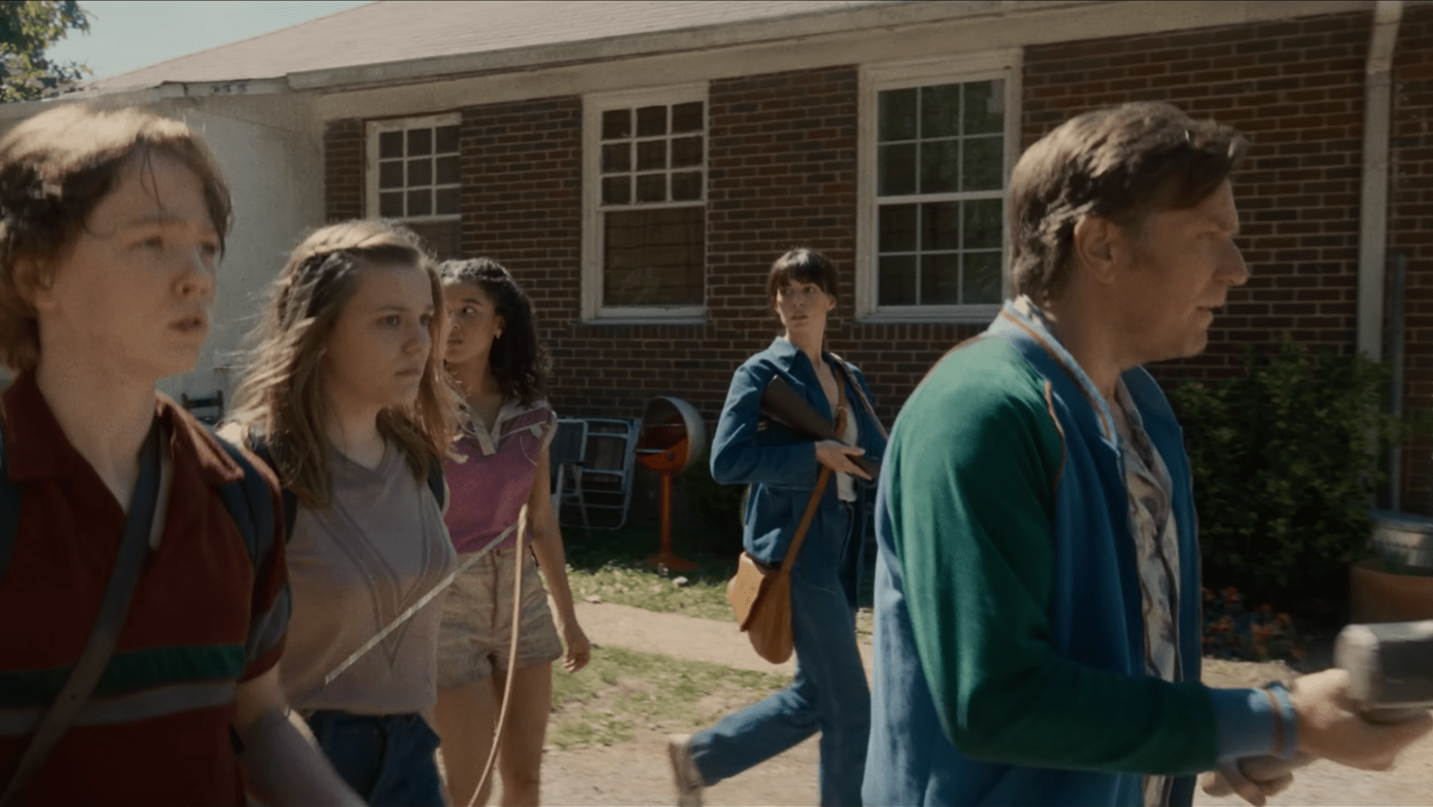 Denise, Brian, Audrey and Jeannette join other residents outside their homes in ‘The End of Oak Street’ (Image Source: YouTube | Warner Bros. Pictures)