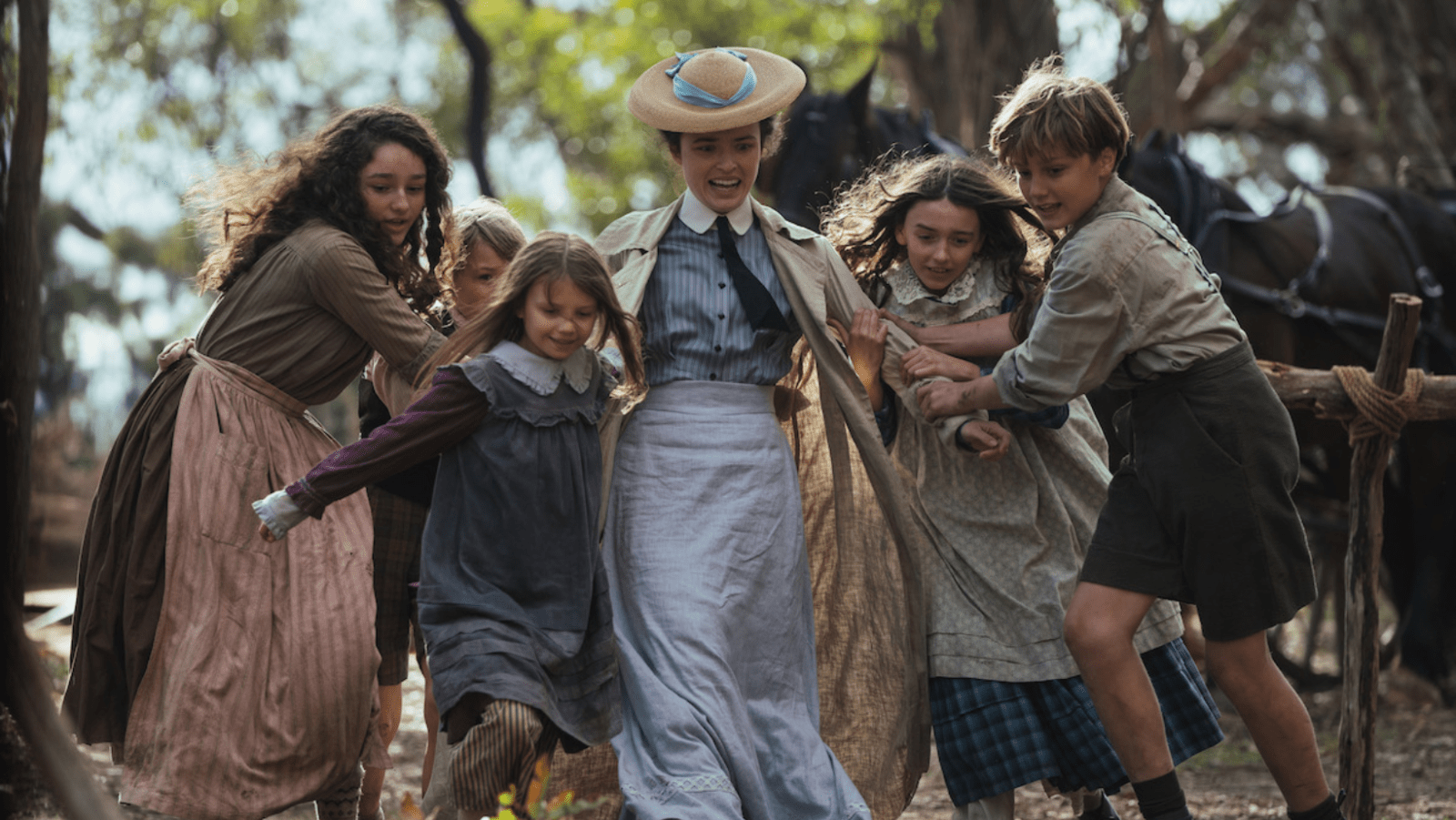 Philippa Northeast as Sybylla Melvyn surrounded by children in ‘My Brilliant Career’ (Image Source: Netflix)