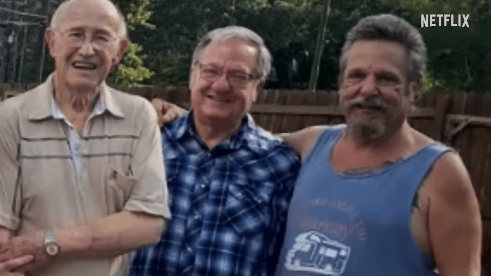 Three men pose together in an archival photograph featured in ‘Freefall: A Reckoning for Boeing’, including whistleblower John Barnett on the right (Image Source: Netflix)