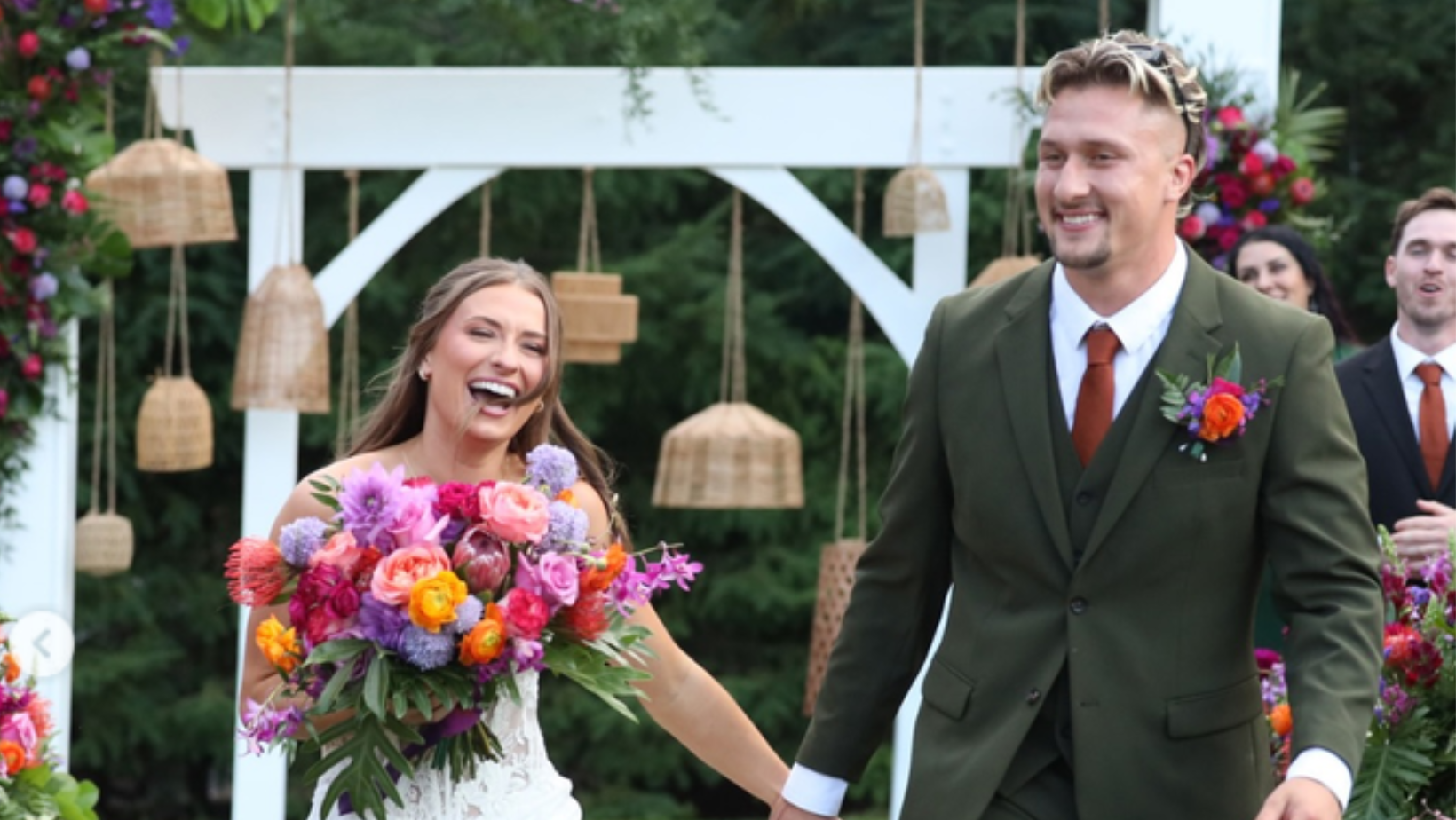 Caitlin Grimm and Devin Short walk hand in hand after their wedding ceremony in 'Married at First Sight' Season 20 (Image Source: Peacock)