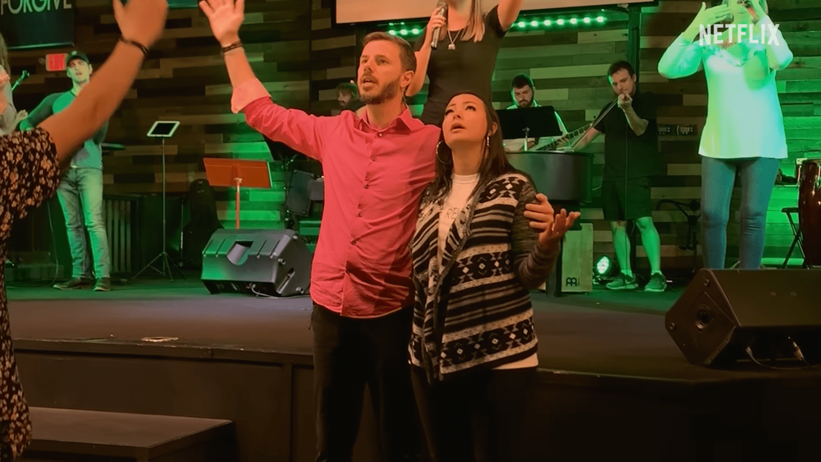 Mica Miller and John-Paul Miller attend a church service in a still from ‘Death of the Pastor’s Wife’ (Image Source: Netflix)