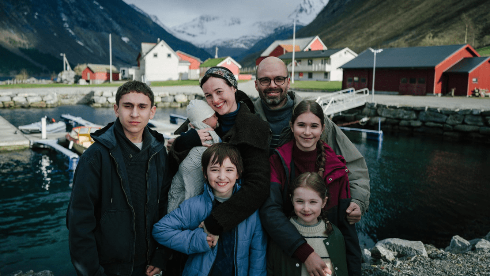 Sebastian Stan as Mihai and Renate Reinsve as Lisbet with the Gheorghiu children in 'Fjord' (Image Source: NEON)