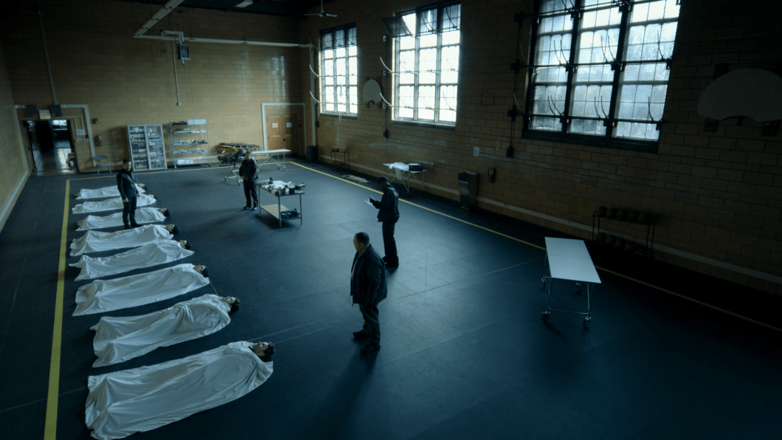 The bodies of alternate versions of Jason Dessen are examined following the confrontation in 'Dark Matter' Season 2 Episode 1 (Image Source: Apple TV)