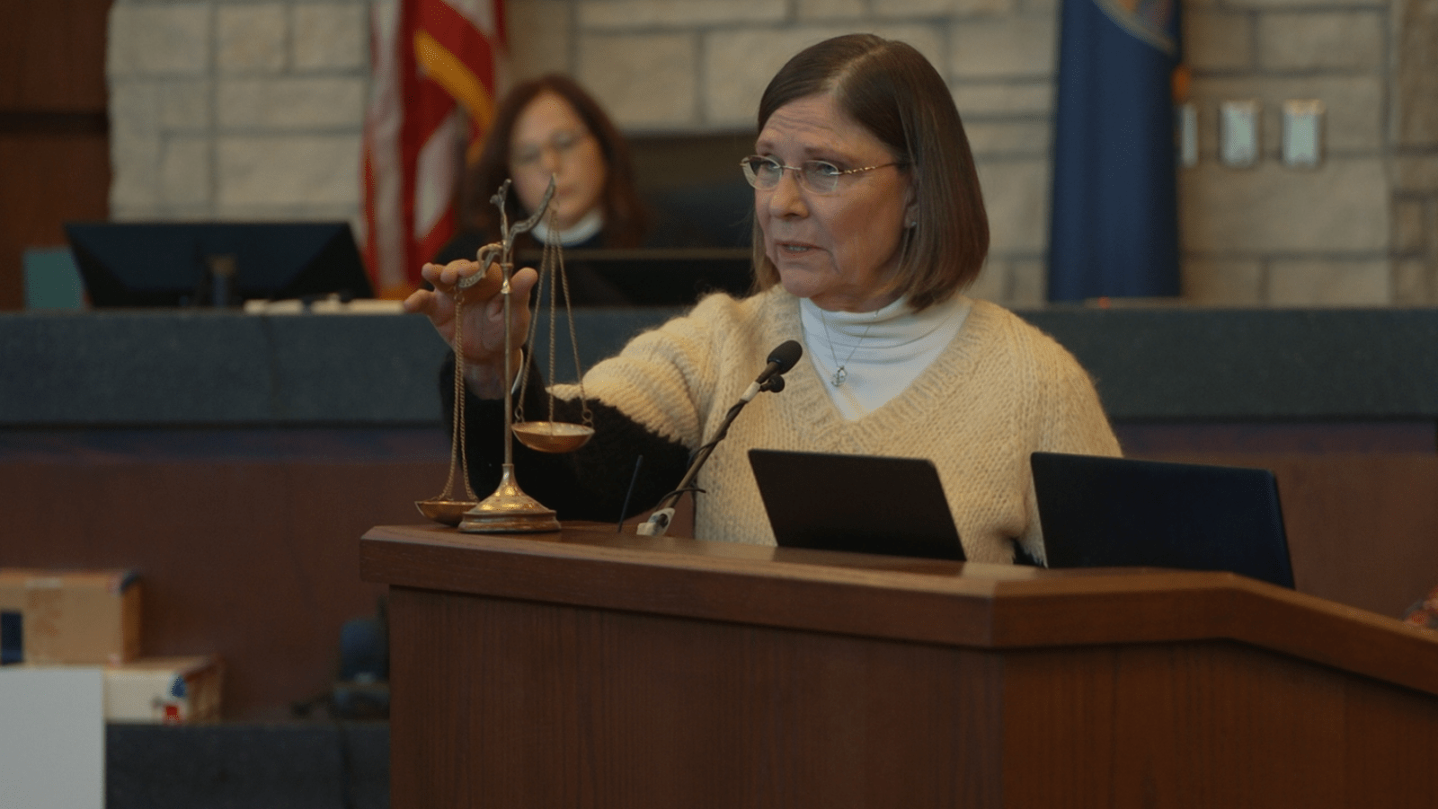 Dana Chandler holds a set of scales during closing arguments in her third murder trial in ‘A Killer Story’ (Image Source: HBO)