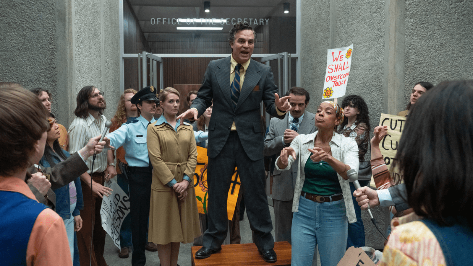 Mark Ruffalo as Joseph A. Califano Jr. addresses protesters and reporters in a still from 'Being Heumann' (Image Source: Apple TV)