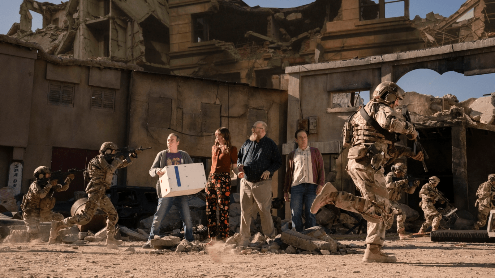 Stuart, Denise, Bert and Kripke find themselves surrounded by soldiers in a war-torn universe in ‘Stuart Fails to Save the Universe’ Episode 7 (Image Source: Colin Remas Brown/HBO Max)