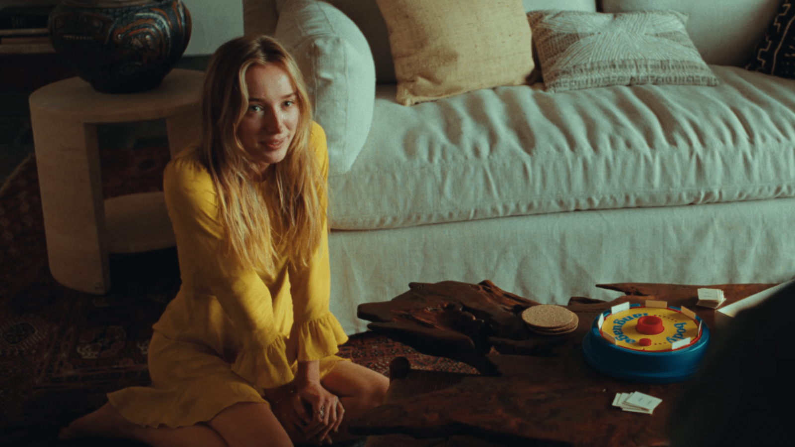Phoebe Dynevor as Wren plays a board game in ‘Remain’ (Image Source: Warner Bros. Pictures)