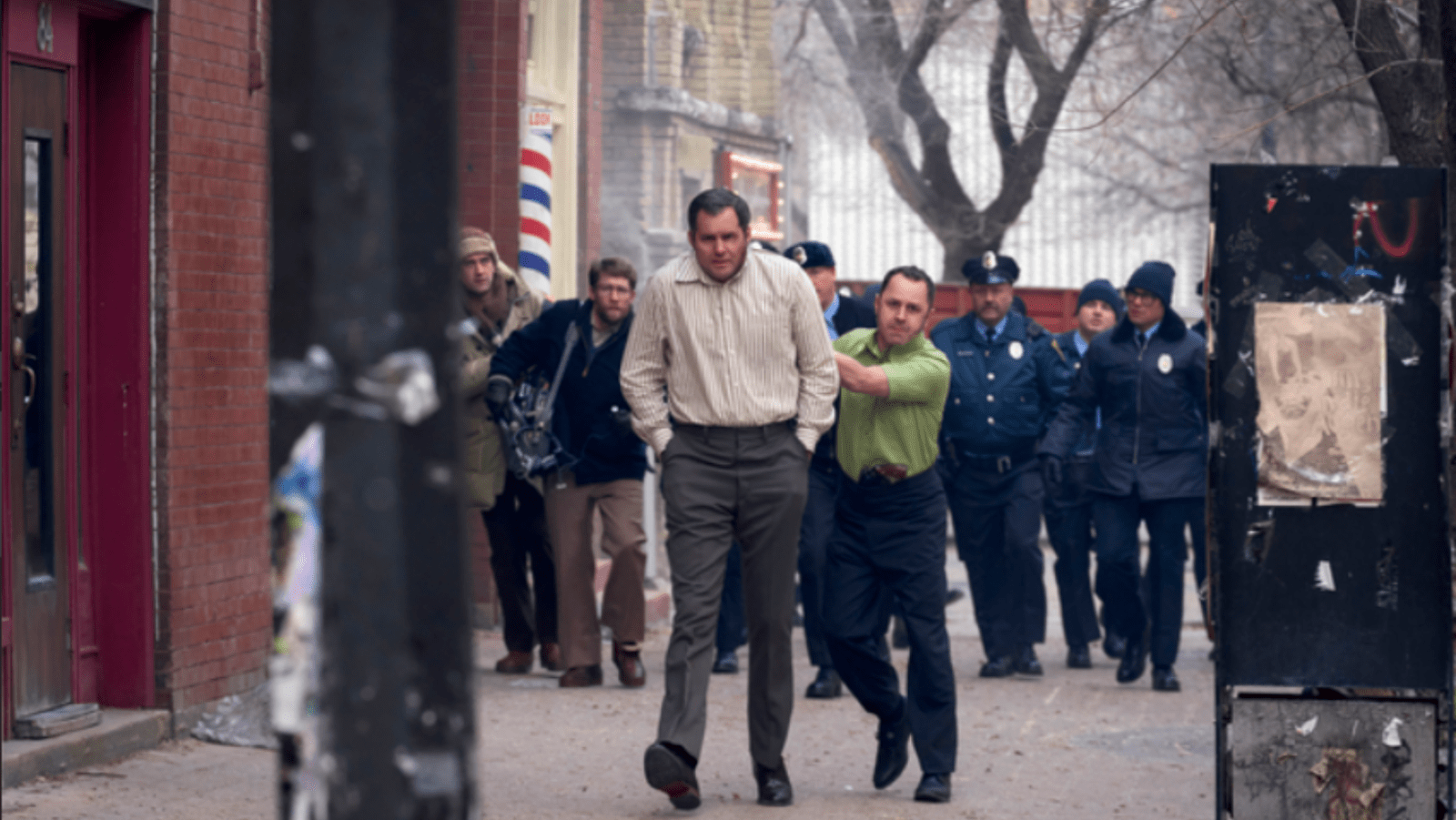 Kristoffer Polaha as Dick Hall is led through Indianapolis by Giovanni Ribisi as Tony Kiritsis in ‘American Hostage’ (Image Source: MGM+)