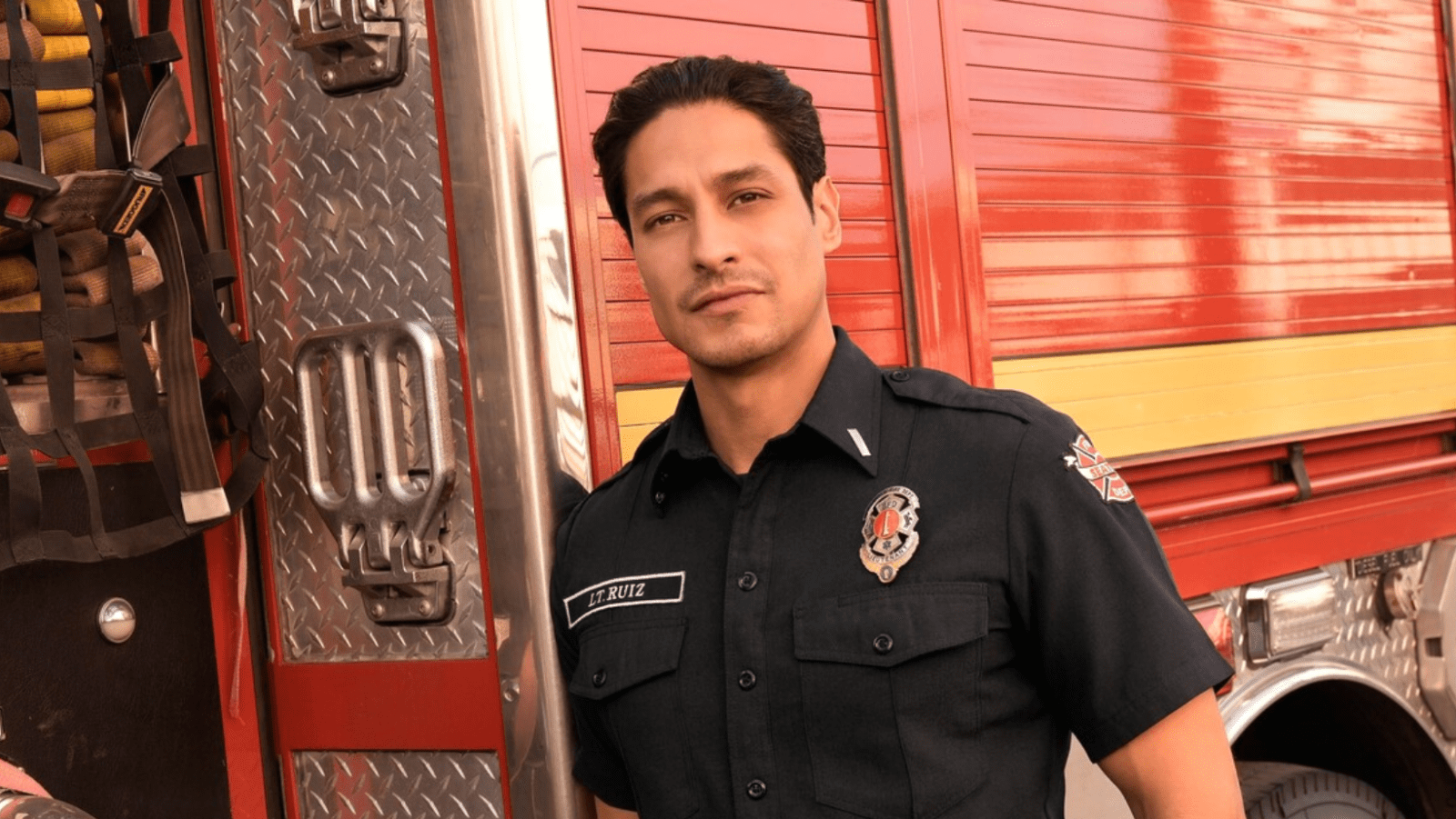 Carlos Miranda as Theo Ruiz beside a fire truck in 'Station 19' (Cover Image Source: ABC)