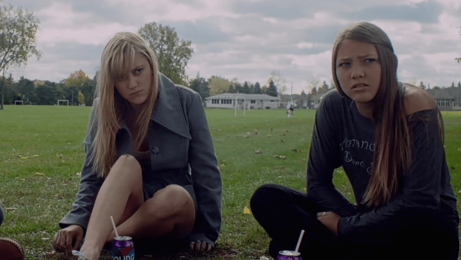 Maika Monroe as Jay Height (left) and Lili Sepe as Kelly sit together in ‘It Follows’ (Image Source: RADiUS-TWC)
