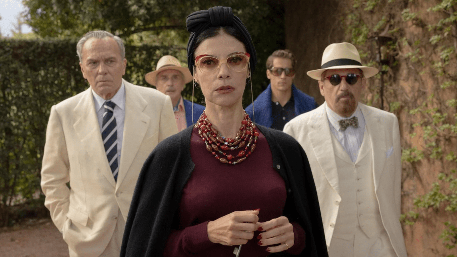 Basil (L) and fellow hotel guests gather outdoors in a scene from 'The Final Problem' (Image Source: Netflix)