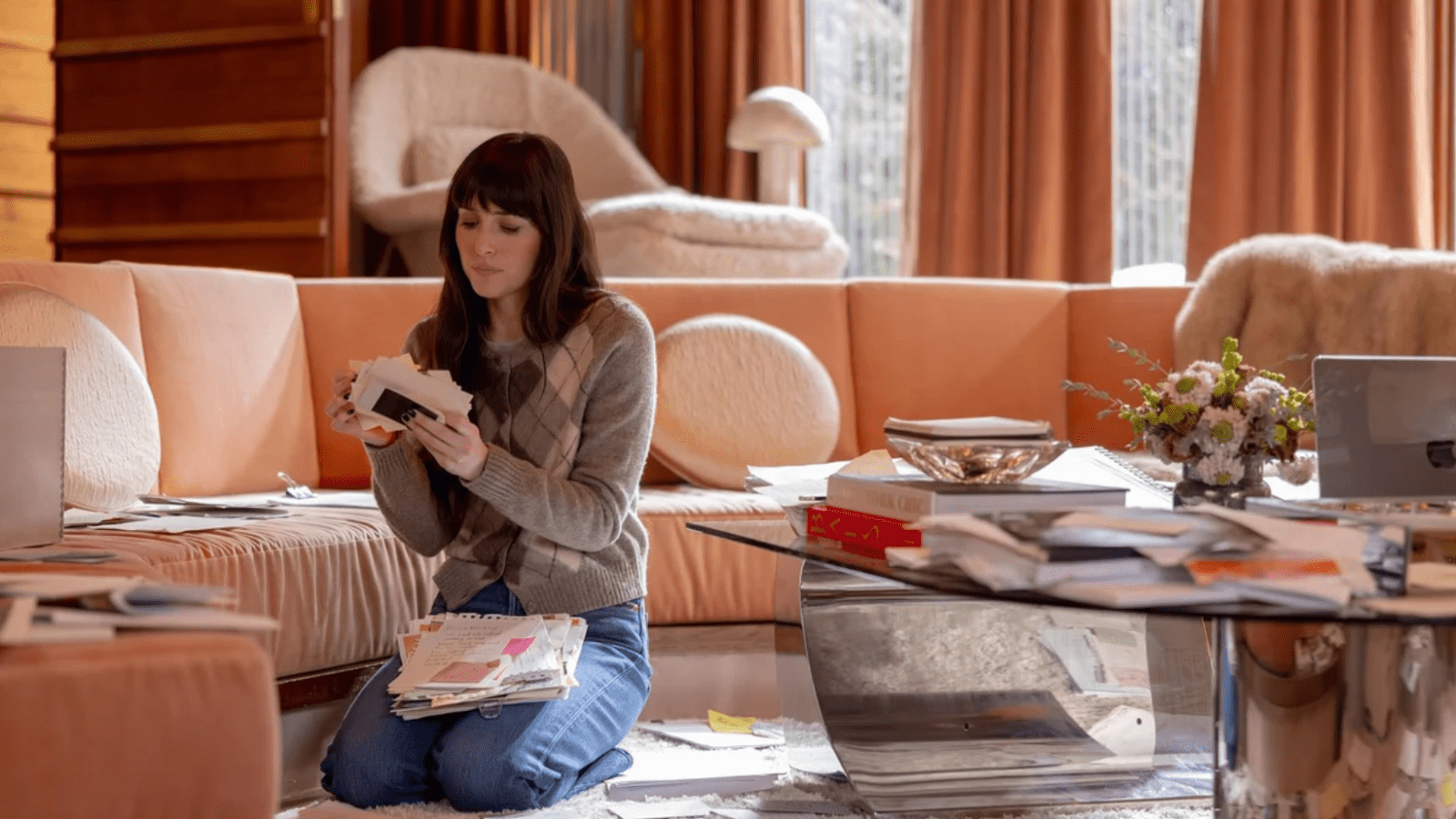 Dakota Johnson as Lowen Ashleigh sorting through Verity Crawford’s notes in the author’s office in ‘Verity’ (Image Source: Amazon MGM Studios)